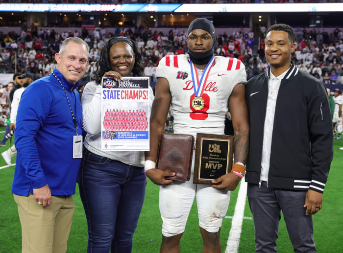 Colin Simmons (No. 8) poses with the 6A Division I state trophy after beating North Shore at AT&T Stadium.